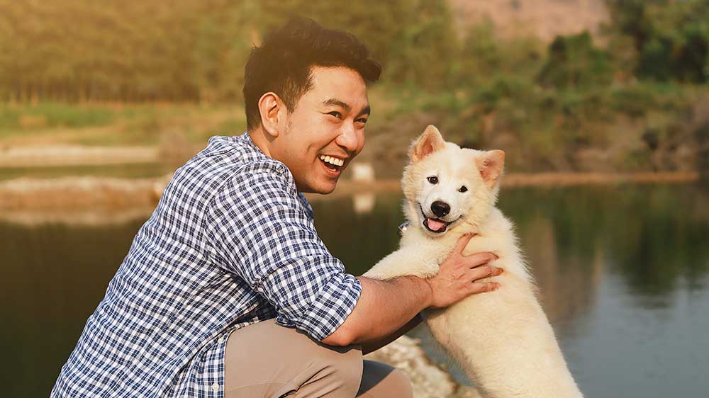 man with dog at lake