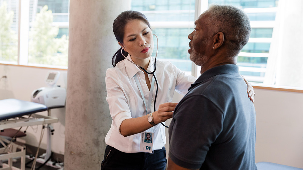 nurse checks heart rate of mater man before physical 